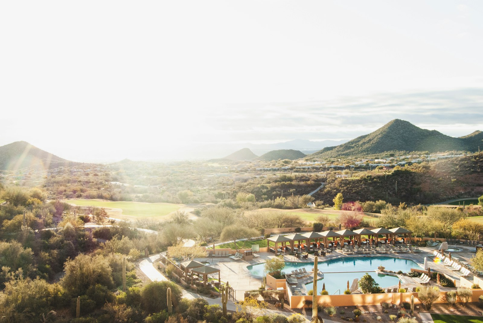 Aerial view of a desert resort and mountains